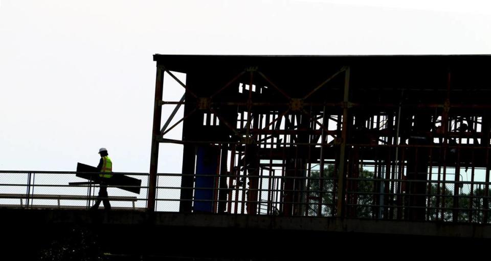 Workers carry debris to a dumpster while working on the suite level at Golden Park in Columbus, Georgia. 04/17/2024 Mike Haskey/mhaskey@ledger-enquirer.com