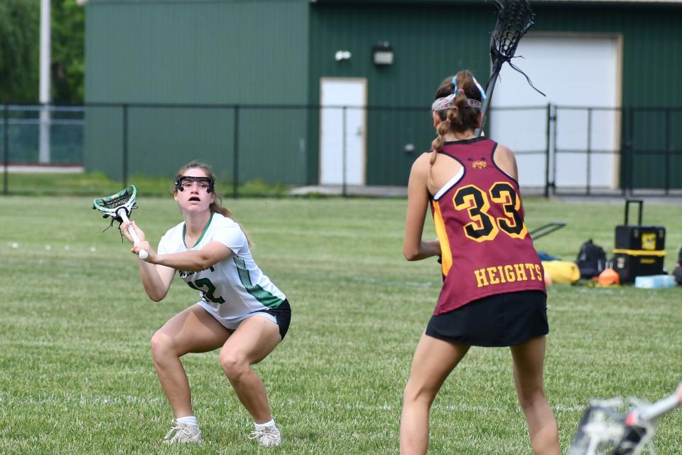 West Deptford senior Amanda Smith eyes up the goal with Haddon Heights freshma Addison Dillon closing in