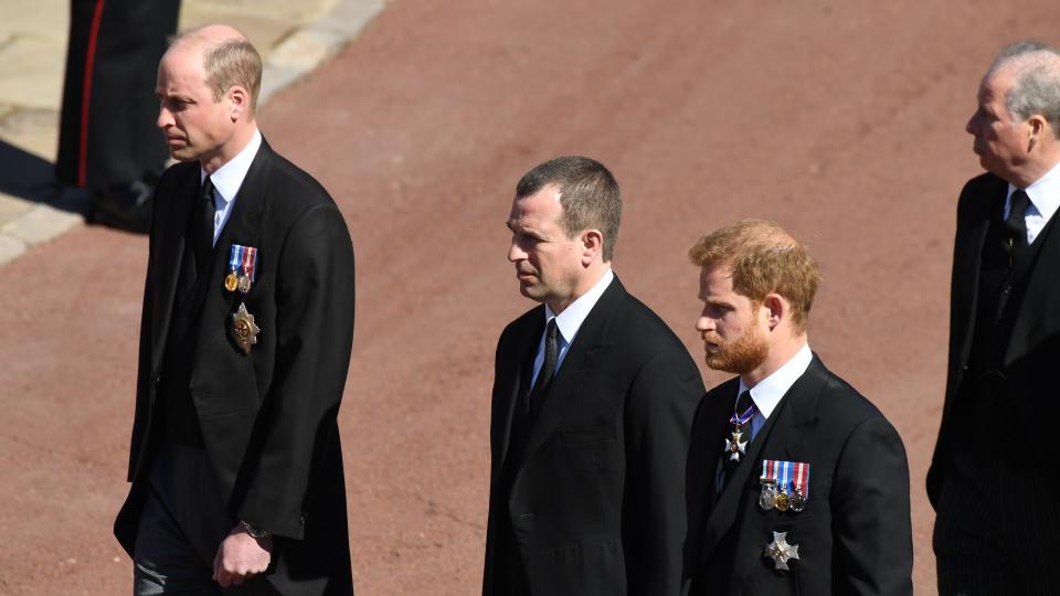 Peter Phillips stands between Prince William and Prince Harry during the funeral procession for their grandfather Prince Philip in Windsor Castle on April 17, 2021