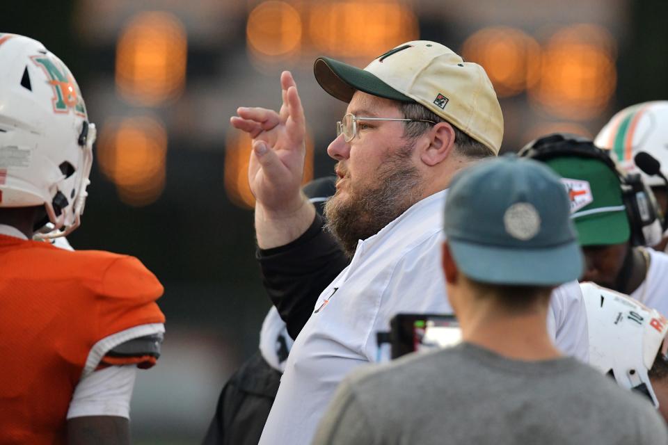Mandarin head coach Toby Bullock talks with his players during first half action. The Atlantic Coast Stingrays traveled to Mandarin to play the Mustangs in High School football Friday, September 15, 2023.