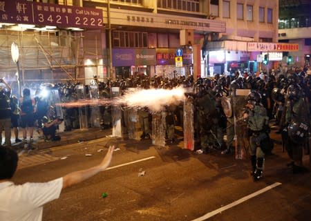 Riot police fire tear gas, after a march to call for democratic reforms in Hong Kong