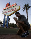 <p>Matt McLeod prays for the victims in front of the “Welcome To Las Vegas” sign Tuesday, Oct. 3, 2017, in Las Vegas. (Photo: Chris Carlson/AP) </p>