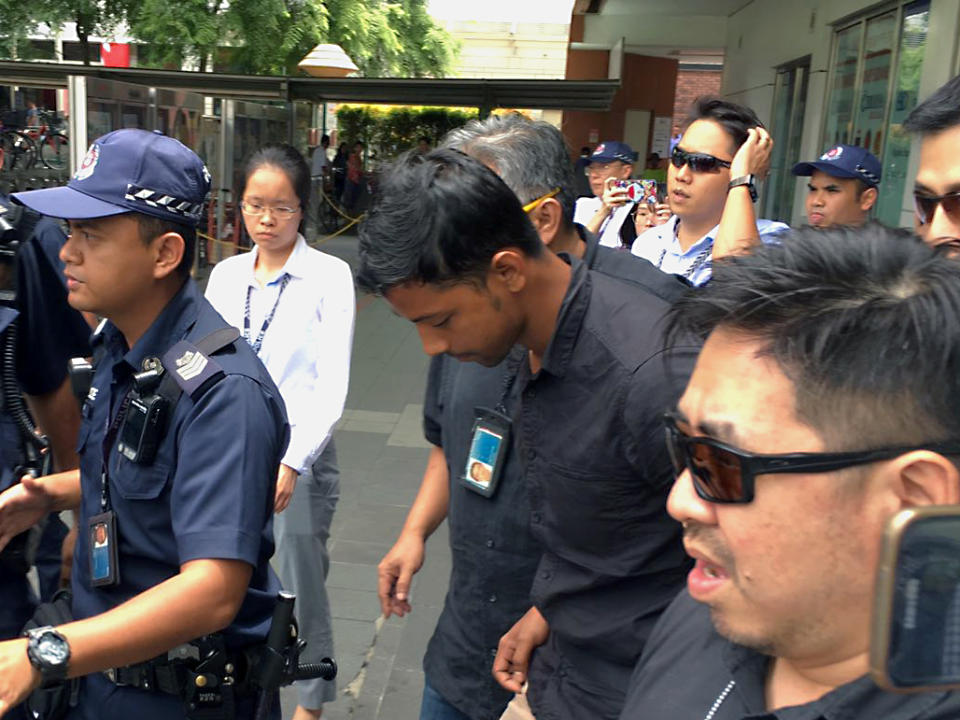 The suspect being escorted back to the crime scene on Thursday (2 August) afternoon. (PHOTO: Nicholas Yong / Yahoo News Singapore)