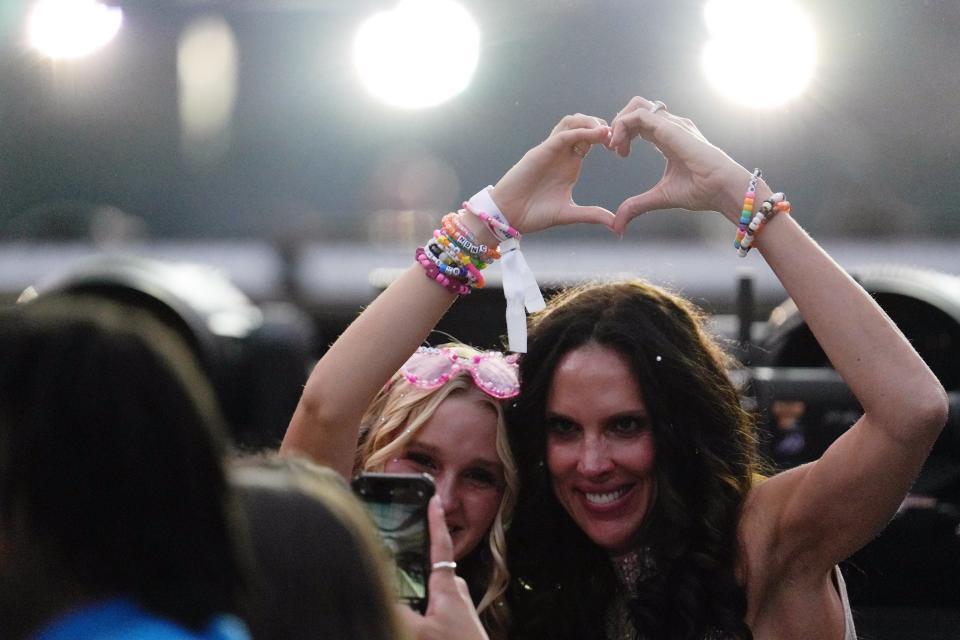 Taylor Swift fans pose before one of her shows at SoFi Stadium, which were filmed for the "Eras Tour" movie.