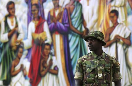 A Ugandan soldier looks on as Pope Francis leads a mass in Kampala, Uganda, November 28, 2015. REUTERS/Stefano Rellandini
