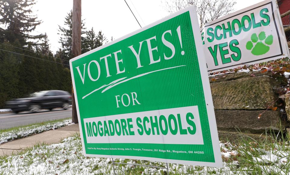 Signs in support of the Mogadore Local School District tax levy stand on the corner of South Cleveland Avenue and Prospect Street on Election Day.
