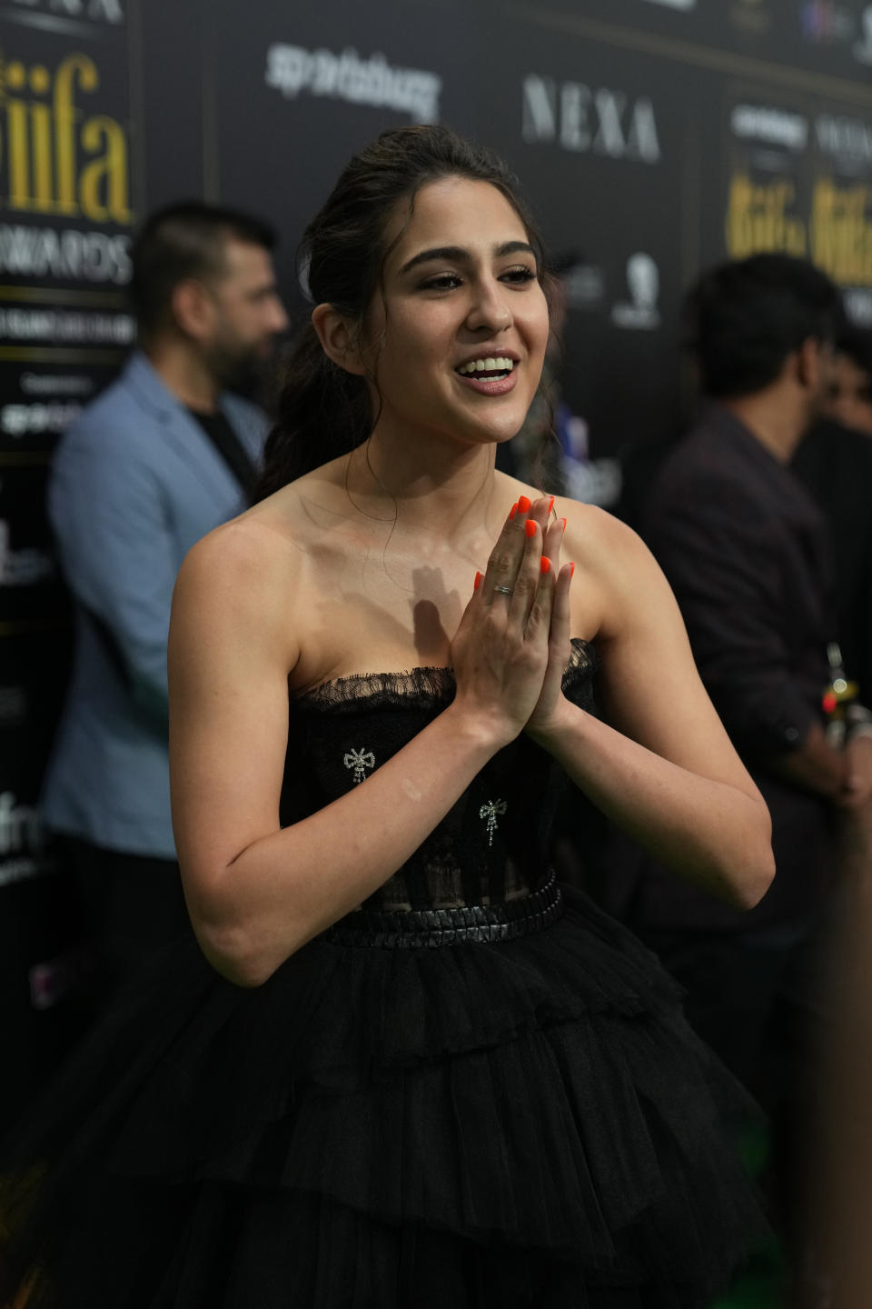 Indian actress Sara Ali Khan greets as she arrives on the green carpet ahead of the 22nd International Indian Film Academy (IIFA) awards in Abu Dhabi, United Arab Emirates, Friday, June 3, 2021. (AP Photo/Kamran Jebreili)