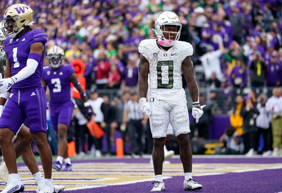 Oregon running back Bucky Irving (0) reacts after scoring a touchdown against Washington during the first half of the game on Oct. 14 in Seattle.