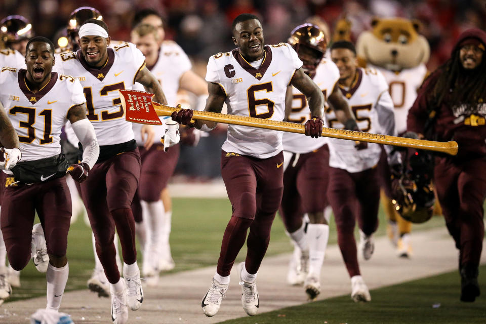 Tyler Johnson (6) celebrates with Paul Bunyan’s Axe after Minnesota beat the Wisconsin Badgers 37-15 to get bowl eligible.(Dylan Buell/Getty Images)