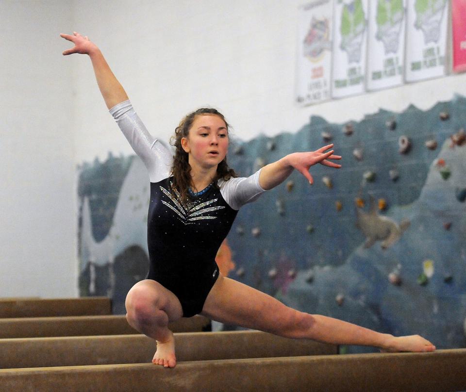 Framingham High School gymnastics team sophomore Maggie Spring on the beam against Needham High School at Shen’s Gymnastics Academy in Holliston, Jan. 14, 2022. Framingham won, 140.9 to 124.8.