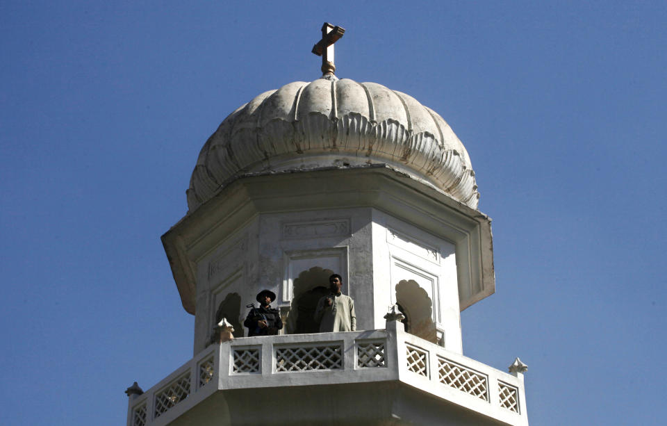 In this Sunday, Nov. 4, 2018, photo a Pakistani security personnel stands guard at a church during Sunday services in Peshawar, Pakistan. Synagogues, mosques, churches and other houses of worship are routinely at risk of attack in many parts of the world. And so worshippers themselves often feel the need for visible, tangible protection even as they seek the divine. (AP Photo/Muhammad Sajjad)