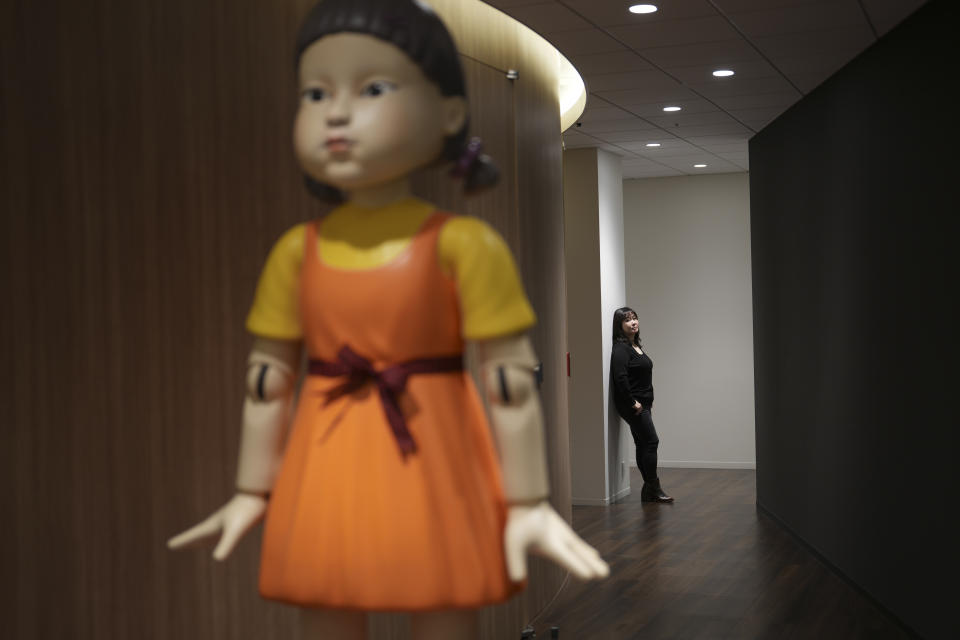 Minyoung Kim, NetflixÕs vice president of content in Asia, stands near a robot doll from the show ÒSquid GameÓ at the company office in Tokyo, on Feb. 1, 2023. Kim brough ÒSquid GameÓ to the world.  (Chang W. Lee/The New York Times)