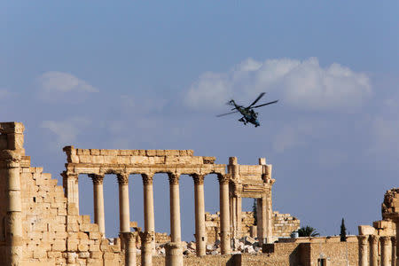 A Russian helicopter flies over the Temple of Bel in the historic city of Palmyra, Syria March 4, 2017. REUTERS/Omar Sanadiki