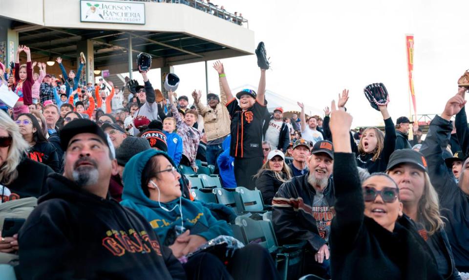 Fans hope to catch free stuff during a giveaway as the San Francisco Giants play the Sacramento River Cats in an exhibition game Sunday.