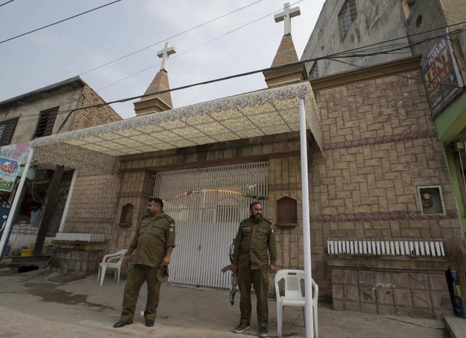 In this Nov2, 2018, photo, Pakistani police officers stand guard outside a church in Rawalpindi, Pakistan. The uproar surrounding Aasia Bibi _ a Pakistani Christian woman who was acquitted of blasphemy charges and released from death row but remains in isolation for her protection _ has drawn attention to the plight of the country's Christians.The minority, among Pakistan's poorest, has faced an increasingly intolerant atmosphere in this Muslim-majority nation where radical religious and sectarian groups have become more prominent in recent years. (AP Photo/B.K. Bangash)