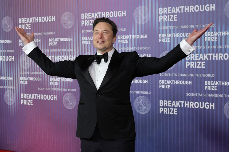 Elon Musk standing against a backdrop that says Breakthrough Prize at a Breakthrough Prize ceremony