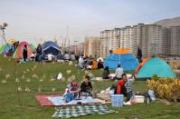 Iranians spend time outdoors observing the ancient festival of Sizdeh Bedar, an annual public picnic day on the 13th day of the Iranian new year, west of Tehran, Iran, Wednesday, April 2, 2014. Sizdeh Bedar, which comes from the Farsi words for “thirteen” and “day out,” is a legacy from Iran’s pre-Islamic past that hard-liners in the Islamic Republic never managed to erase from calendars. State media and calendar makers choose to call the festival “Nature Day” instead of Sizdeh Bedar, given the bad-luck associations with the number 13. (AP Photo/Ebrahim Noroozi)