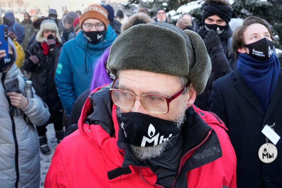 Supporters of the Memorial human rights group wearing face masks with the words “The Memorial cannot be banned!” gather in front of the Moscow Court (Alexander Zemlianichenko/AP/PA) (AP)