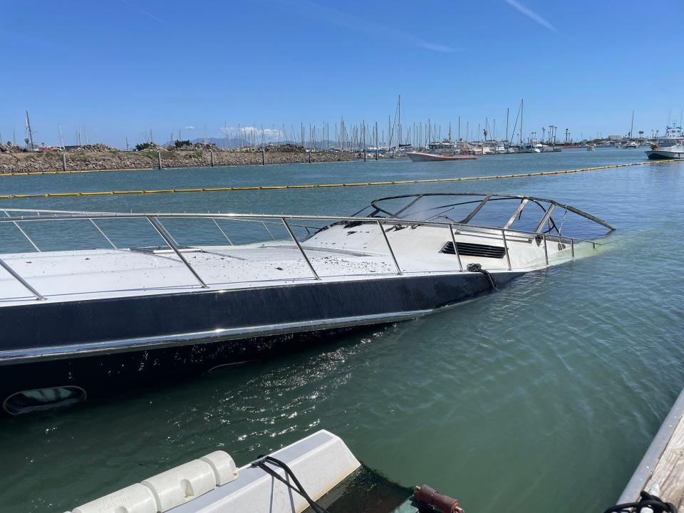 Yellow line stretched around the scene of a boat fire at Channel Islands Harbor Friday was deployed to contain any floating hazardous materials, fire officials said.