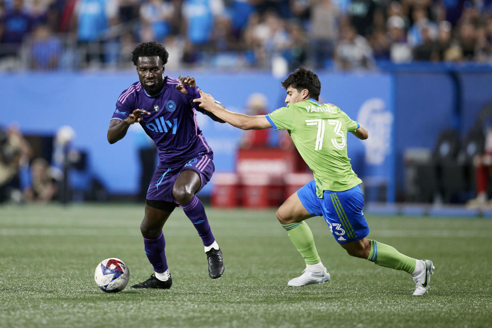 Charlotte FC midfielder Derrick Jones (20) battles for the ball with Seattle Sounders midfielder Obed Vargas (73) during an MLS soccer match, Saturday, June 10, 2023, in Charlotte, N.C. (AP Photo/Brian Westerholt)