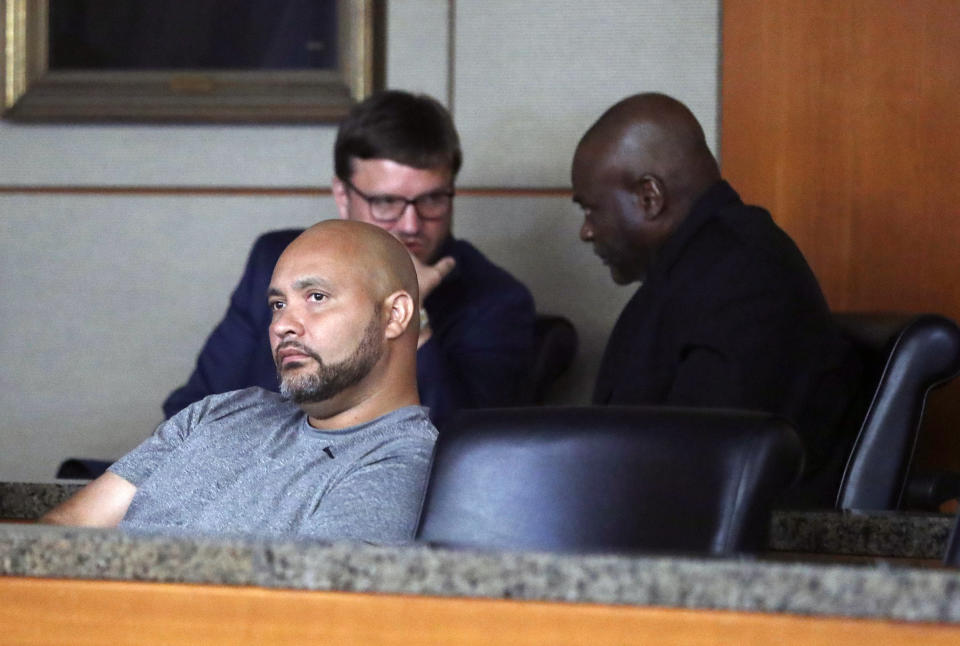 Former Houston police officers Steven Bryant, foreground, and Gerald Goines, background, turn themselves in at the Civil Courthouse, Friday, August 23, 2019, in Houston. Goines, a former Houston police officer has been charged with murder in connection with the deadly January drug raid of a home that killed a couple who lived there and injured five officers, prosecutors announced Friday. (Karen Warren/Houston Chronicle via AP)