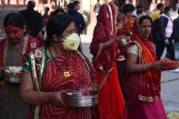 A reveller wearing a facemask amid fears of the spread of COVID-19 novel coronavirus, arrives to celebrate Holi, the spring festival of colours, in Kathmandu on March 9, 2020. - Holi is observed at the end of the winter season on the last full moon of the lunar month. (Photo by PRAKASH MATHEMA / AFP) (Photo by PRAKASH MATHEMA/AFP via Getty Images)