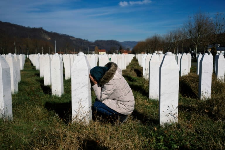 A woman cries over a relative's grave at the memorial centre of Potocari near Srebrenica