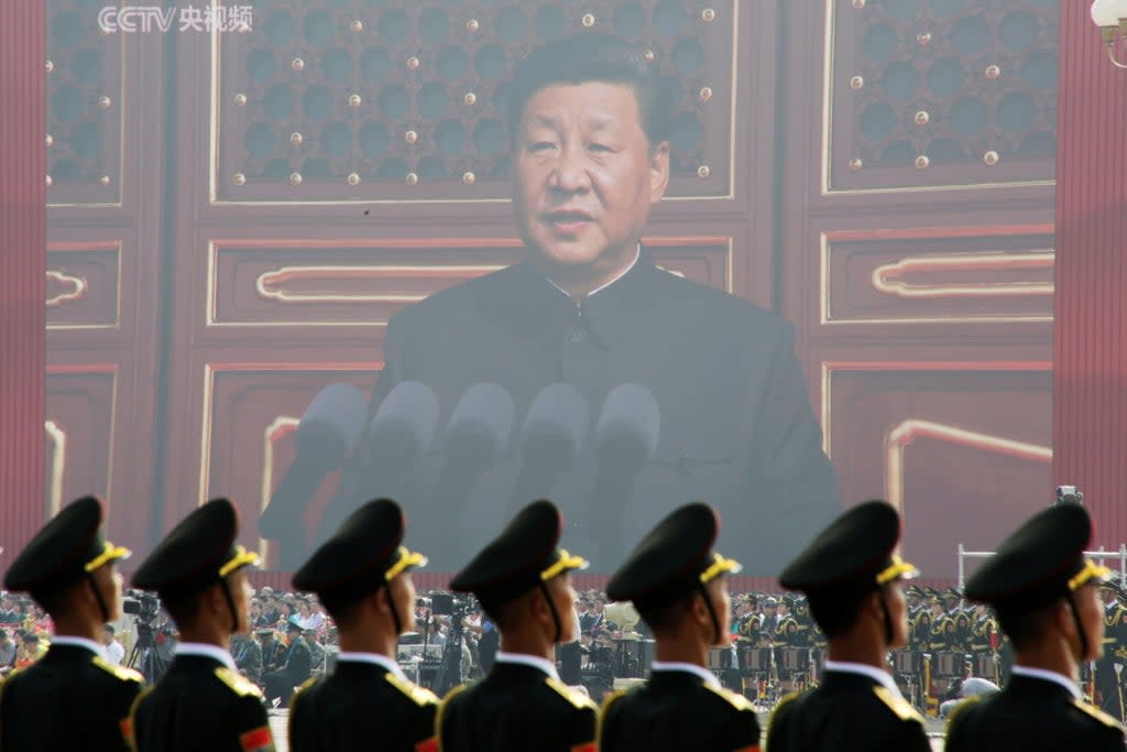 File photo: Soldiers of People's Liberation Army (PLA) are seen before a giant screen as Chinese President Xi Jinping speaks at a military parade  in 2019  (REUTERS)