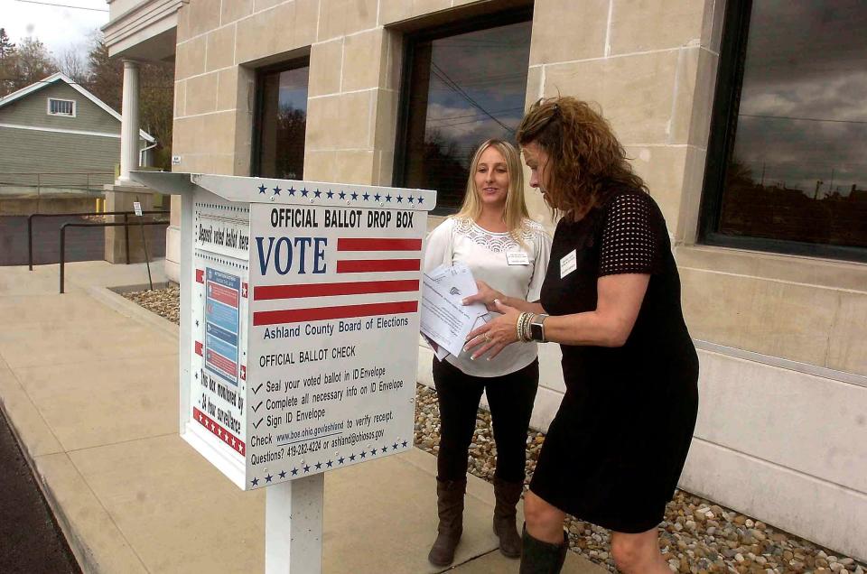Amanda Jones and Shannon Johnson of the Ashland County Board of Elections unload ballots from the drop box at the office Tuesday. Things were relatively calm with no in-person voting at the office on election day.