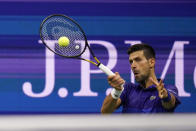 Novak Djokovic, of Serbia, returns to Matteo Berrettini, of Italy, during the quarterfinals of the U.S. Open tennis tournament Wednesday, Sept. 8, 2021, in New York. (AP Photo/Frank Franklin II)