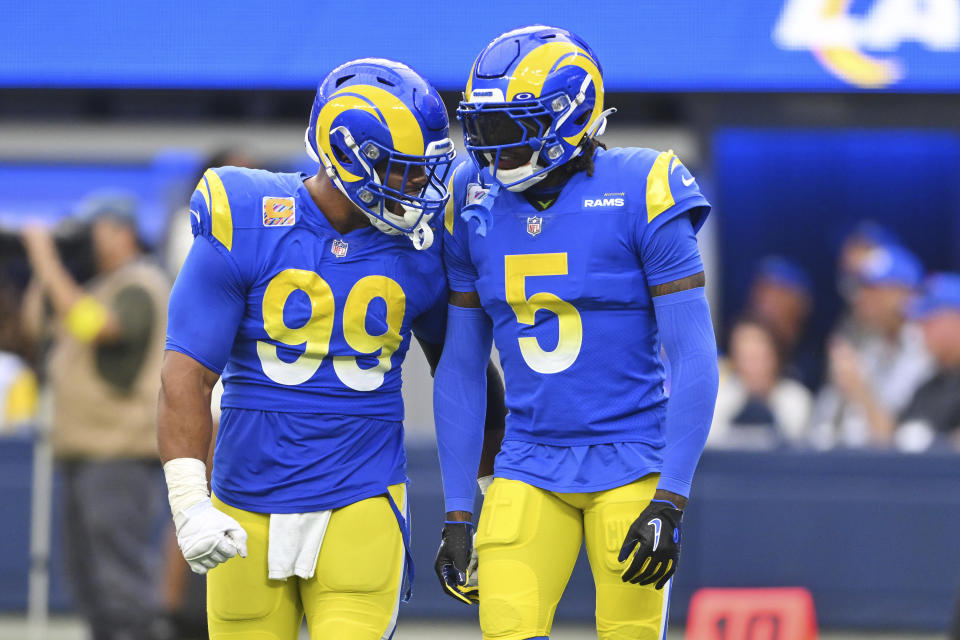 Los Angeles Rams cornerback Jalen Ramsey (5) celebrates with defensive tackle Aaron Donald (99) after Ramsey tackled Carolina Panthers running back Christian McCaffrey during the second half of an NFL football game Sunday, Oct. 16, 2022, in Inglewood, Calif. (AP Photo/Jayne Kamin-Oncea)