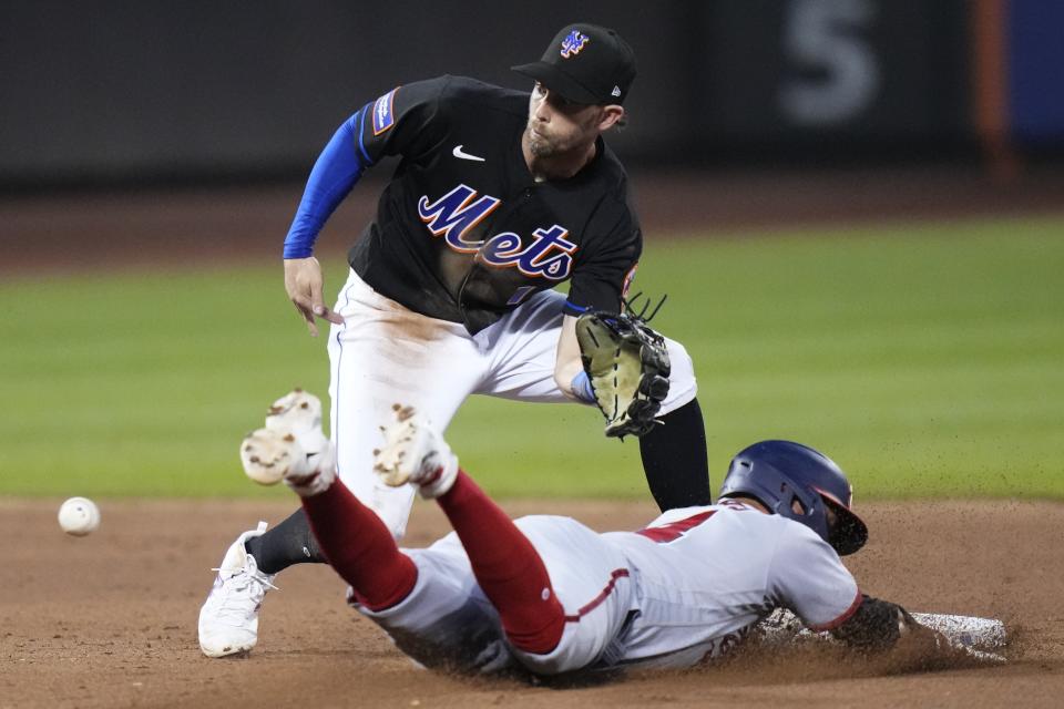 New York Mets' Jeff McNeil (1) waits for the ball as Washington Nationals' Ildemaro Vargas (14) attempts to steal second base during the fifth inning of a baseball game Friday, July 28, 2023, in New York. Vargas was out. (AP Photo/Frank Franklin II)