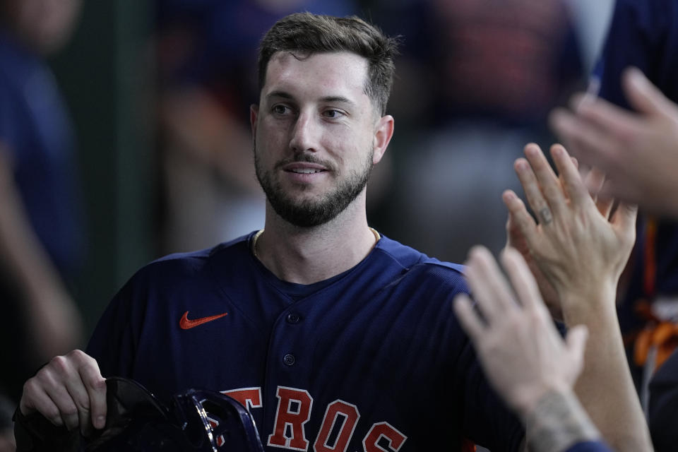 Houston Astros' Kyle Tucker is congratulated in the dugout after scoring against the Seattle Mariners during the first inning of a baseball game Saturday, July 8, 2023, in Houston. (AP Photo/Kevin M. Cox)