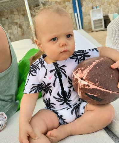 <p>Brittany Mahomes/Instagram</p> Brittany's son 15-month-old Bronze was snapped with a football during the trip