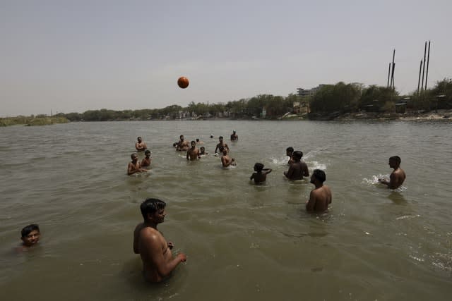 ndian youth cool off in  the River Yamuna in New Delhi, India (Manish Swarup/AP)