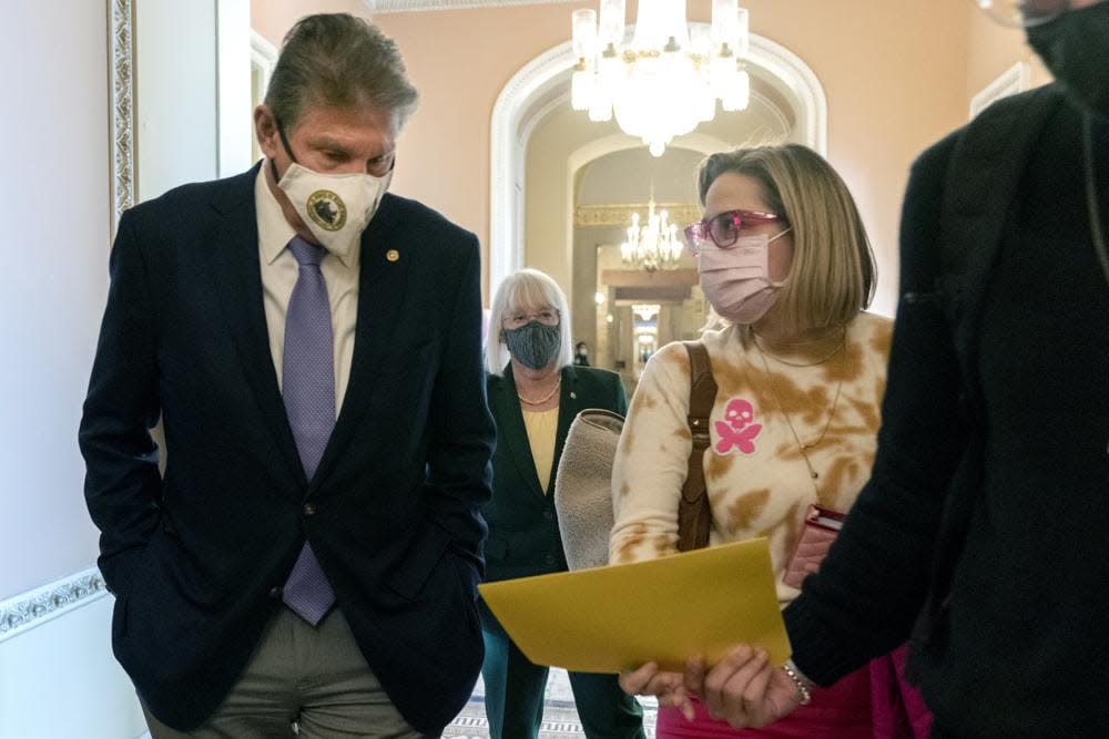 Sen. Joe Manchin, D-W.Va., left, walks with Sen. Kyrsten Sinema, D-Ariz., with Sen. Patty Murray, D-Wash., behind them at center, after attending a Democratic policy luncheon, on Nov. 16, 2021, on Capitol Hill in Washington. (AP Photo/Jacquelyn Martin, File)