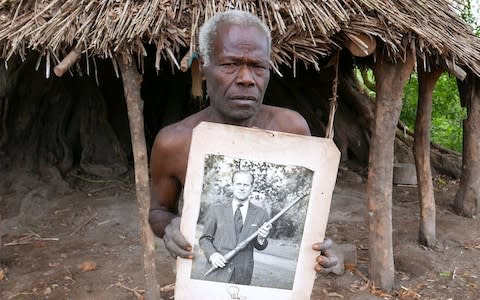 A portrait of Prince Philip posing with a traditional pig-killing club, a gift from the islanders, is displayed in Younanen.  - Credit: Reuters/STAFF
