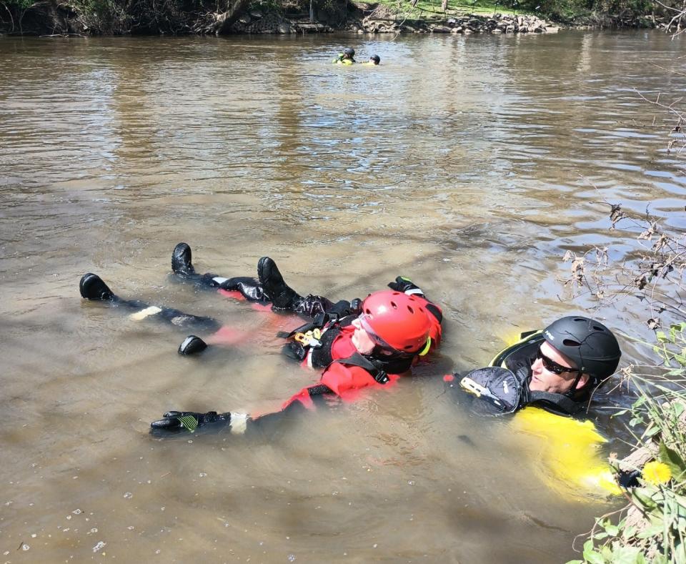 Capt. Matt Casper, right, of the Jackson Township Department, and Massillon firefighter Scott Borojevich participate in a water rescue drill  in the Tuscarawas River in Massillon.
