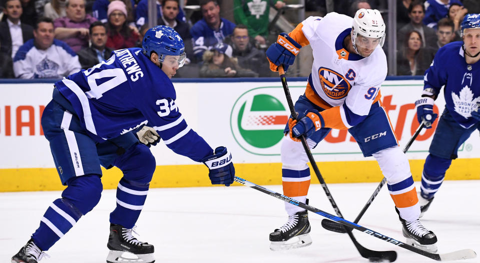 Auston Matthews and John Tavares fight for the puck during a regular season game between the New York Islanders and Toronto Maple Leafs on January 31, 2018. (Photo by Gerry Angus/Icon Sportswire via Getty Images)