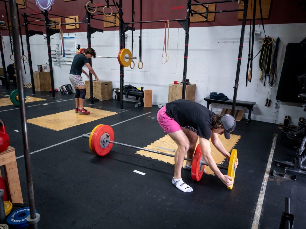 People are pictured working out at Engineered Bodies Strength & Conditioning in Port Moody, B.C., hours before restrictions came into effect in Port Moody, B.C., on Dec. 22. (Ben Nelms/CBC - image credit)