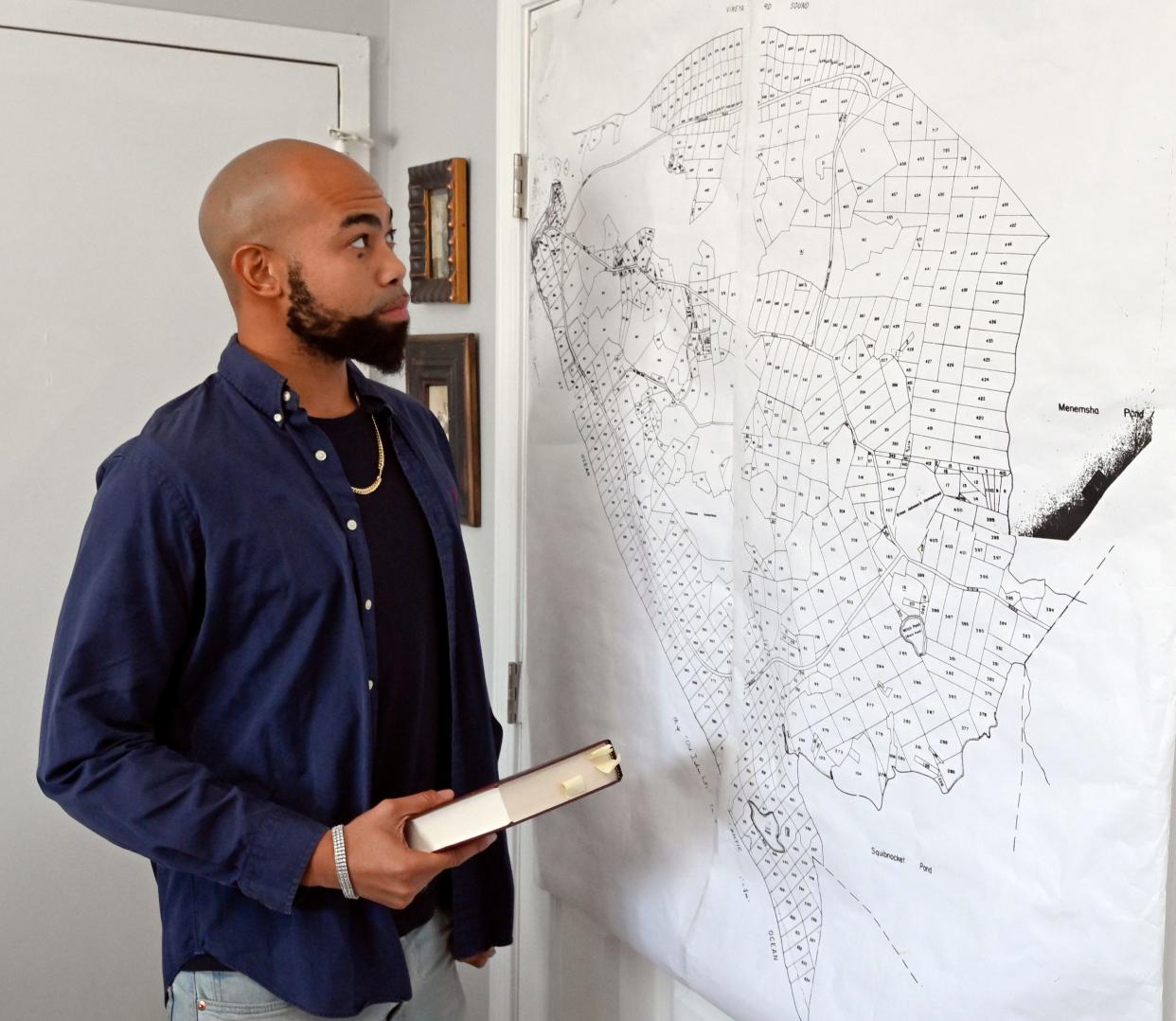 Troy Small, one of the defendants in the lawsuit brought by Vineyard Conservation Society, questioned the validity of the 1945 deed. He was photographed in October 2022 with a map of Aquinnah land parcels.