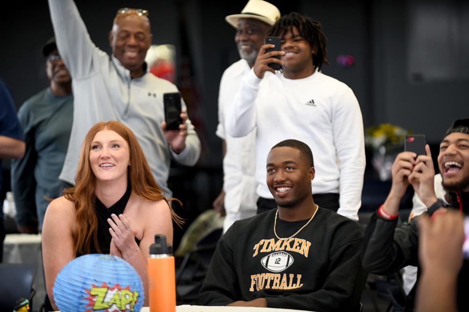 Former McKinley and Timken quarterback Dominique Robinson celebrates with wife Emma and family after being drafted by the Bears in the fifth round of the NFL Draft surrounded by friends and family at Stark State Business and Entrepreneurial Center, Saturday.