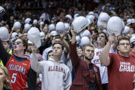 Alabama fans salute a veteran during the first half of an NCAA college basketball game against Jacksonville State, Friday, Nov. 18, 2022, in Tuscaloosa, Ala. (AP Photo/Vasha Hunt)