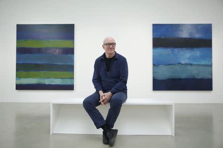 Artist Sean Scully poses with his works "Landline BrŸke 5.14" (L) and "Landline Blue Blue" at the Timothy Taylor Gallery in London November 20, 2014. REUTERS/Luke MacGregor