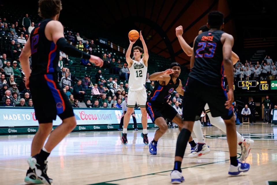 Feb 15, 2023; Fort Collins, Colorado, USA; Colorado State Rams forward Patrick Cartier (12) attempts a shot as Boise State Broncos guard Max Rice (12) and forward Naje Smith (23) look on in the second half at Moby Arena. Mandatory Credit: Isaiah J. Downing-USA TODAY Sports