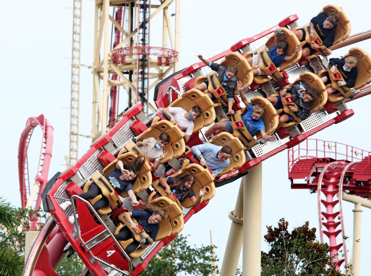 Visitors ride a roller coaster at Universal Studios theme park on the first day of reopening from the coronavirus pandemic, on June 5, 2020, in Orlando, Florida. (Photo by Gregg Newton / AFP) (Photo by GREGG NEWTON/AFP via Getty Images)