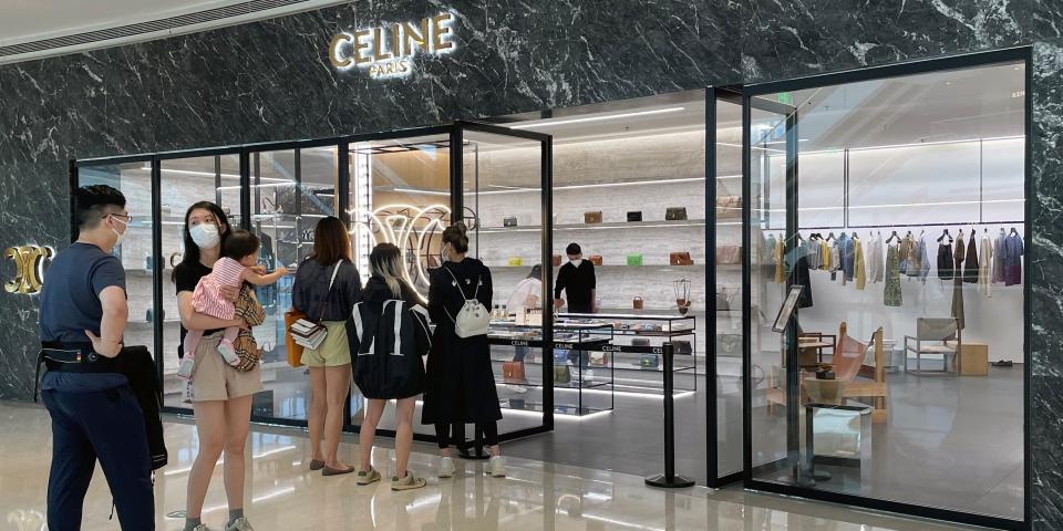 People wearing face masks line up outside a store of French luxury brand Celine, at a reopened shopping mall amid the coronavirus disease (COVID-19) outbreak in Shanghai, China.