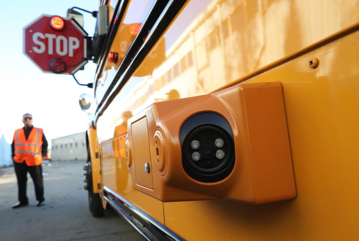 A front and back facing camera unit mounted on the side of a bus at the First Student Bus Depot in Yonkers Nov. 8, 2023. The cameras can identify cars that pass through a bus' stop sign.