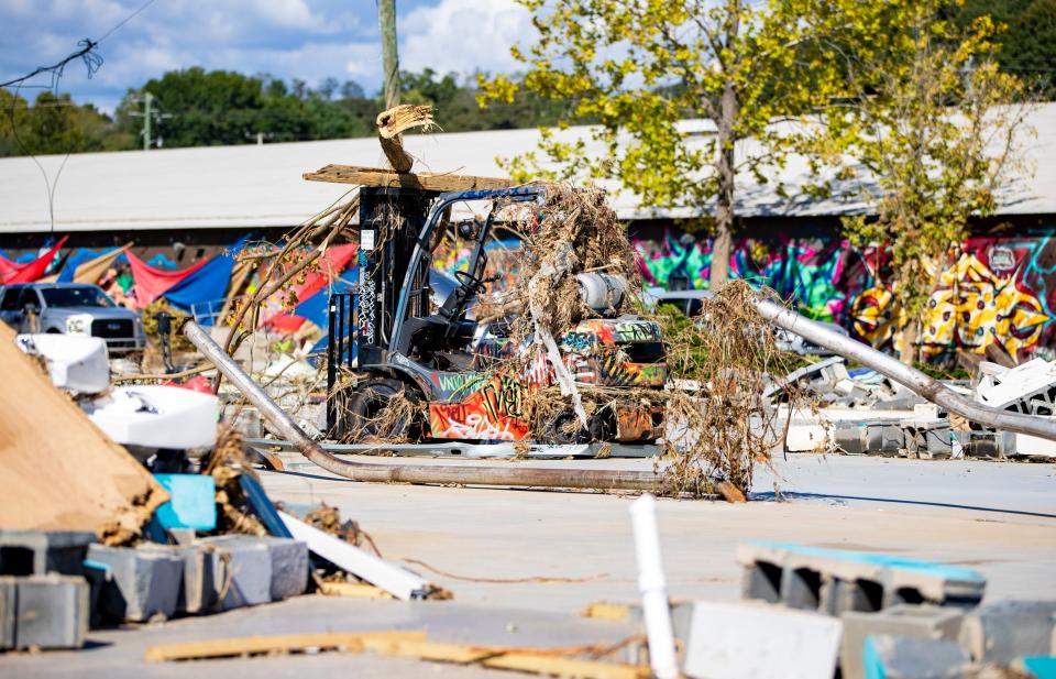 Debris lies on top of a forklift in the River Arts District in Asheville Wednesday afternoon.