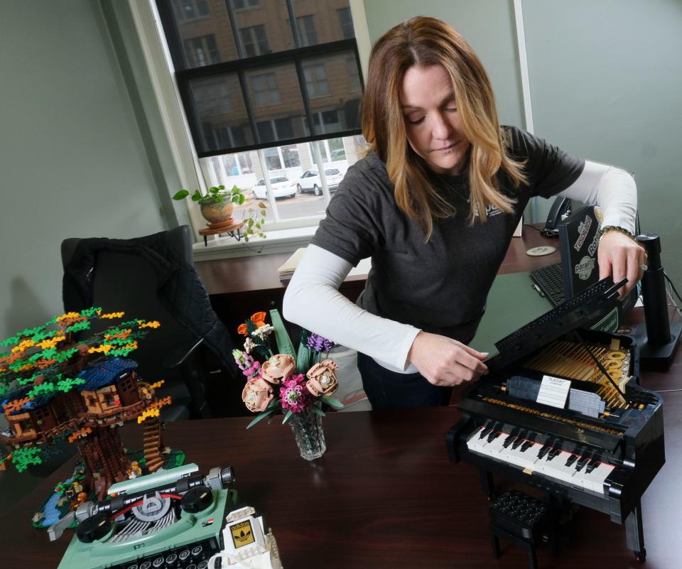 Feb 9, 2024; Tuscaloosa, Alabama, USA; Adrian Cleckler, the chief operating officer of PARA, is into Legos in a big way. Cleckler allows herself one very nice Lego build every year. Cleckler shows off her most recent project, a grand piano.